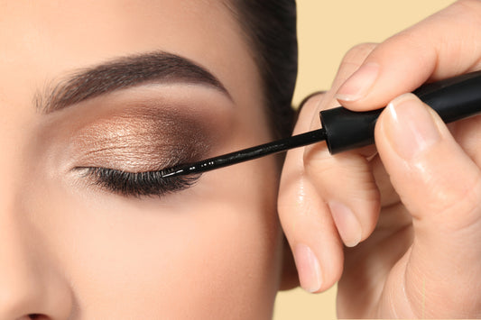 Woman with lash extension getting eyeliner in her eyes