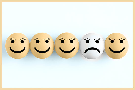 Image of smiley face with one sad face