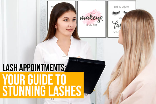 An image of a lash technician holding a black folder, discussing with a client in a consultation setting.