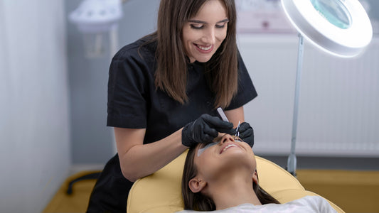 Lash artist giving lash session to a client 